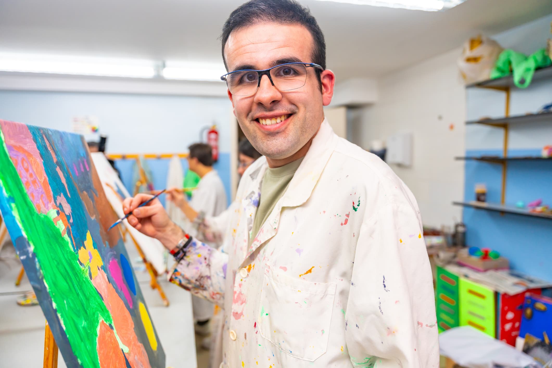 A special needs adult painting a picture